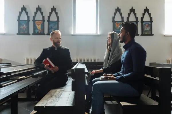a minister talking to a couple inside the church from CHURCH IN DALLAS in Dallas, TX - Youth Ministry